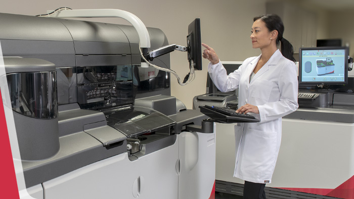 woman using a Vitros machine