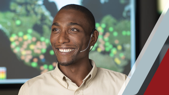 man smiling while wearing a headset